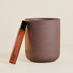 soy coconut candle and fragrance roller set with warm oud and patchouli scent