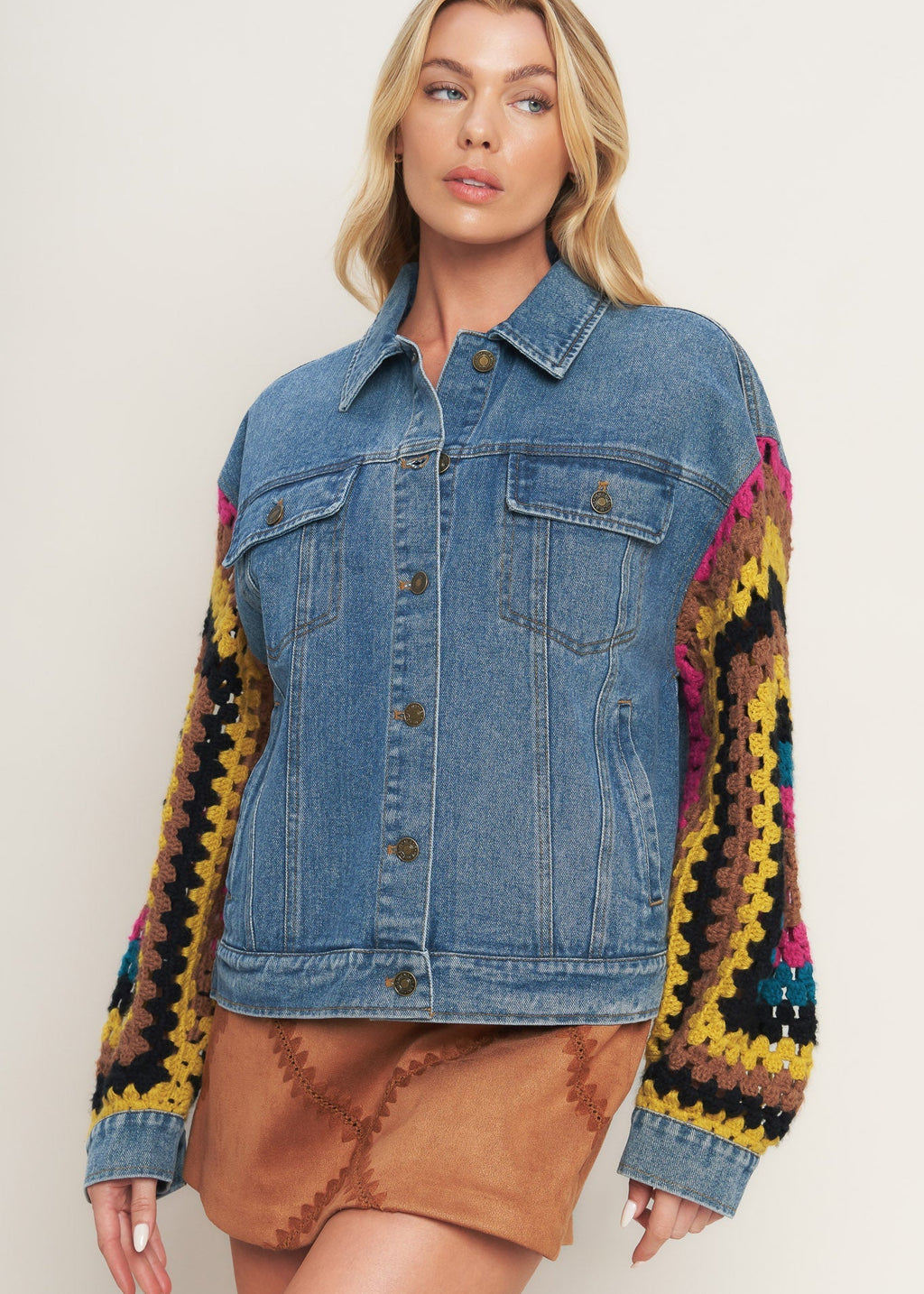 Women's washed denim jacket with crochet sleeves styled as a statement jacket
