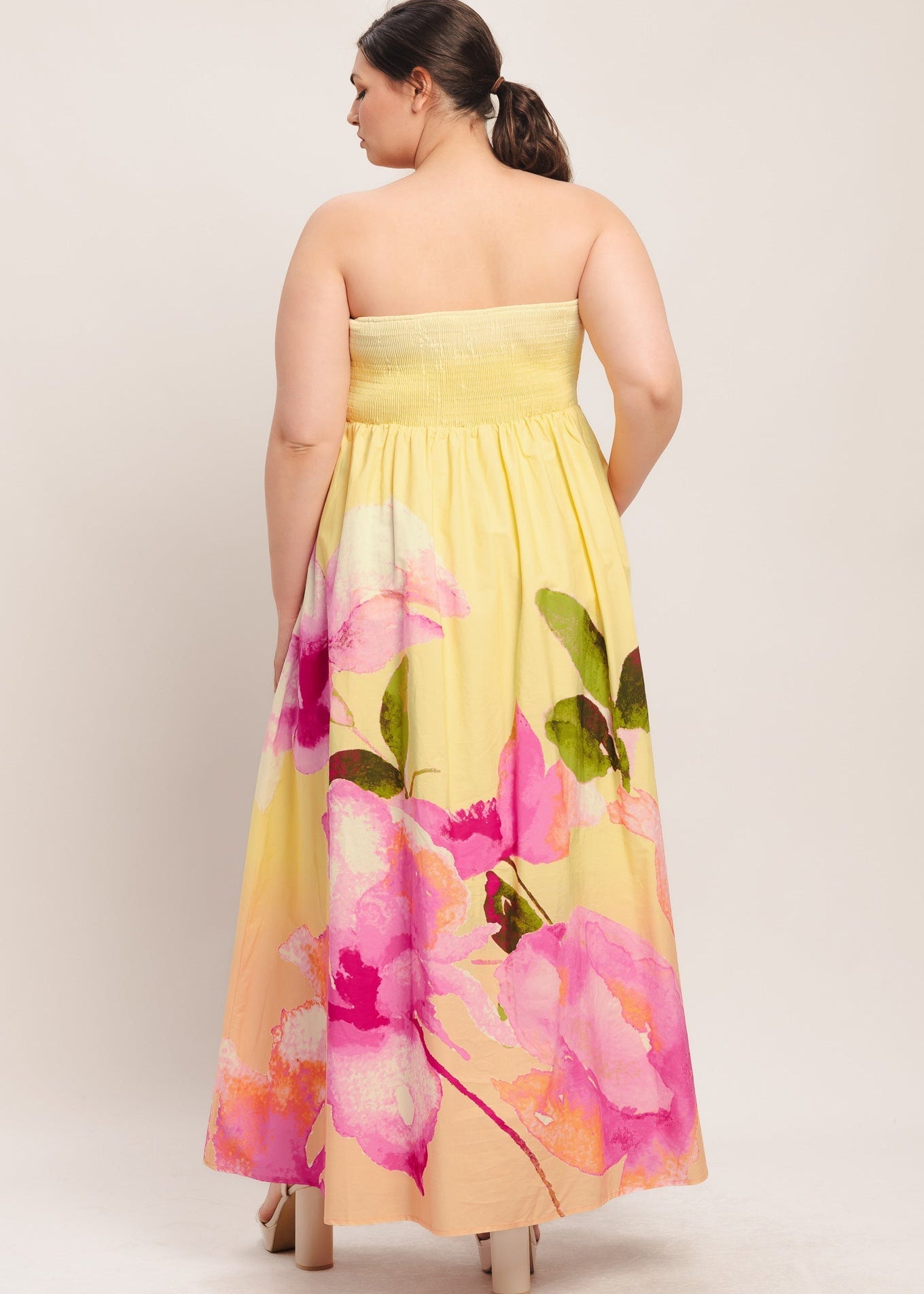 Back view of the yellow ombre pink floral strapless maxi dress
