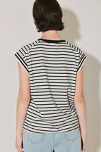 Person wearing a black and white striped shirt against a plain background