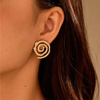 Close-up of a person wearing a spiral earring with a blurred background
