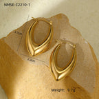 Gold hoop earrings on a textured beige surface with measurements and weight displayed.