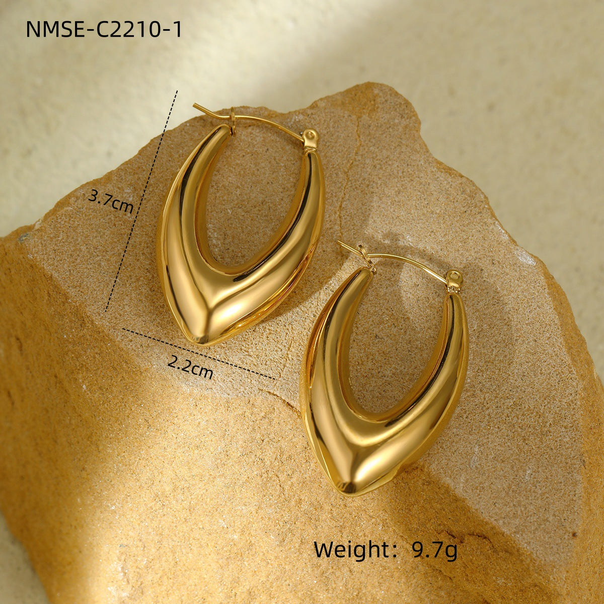 Gold hoop earrings on a textured beige surface with measurements and weight displayed.