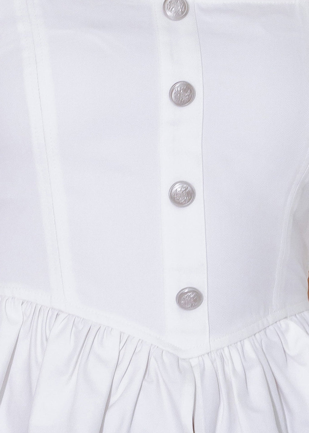 Close-up of a white dress with buttons on a white background