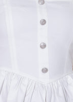 Close-up of a white dress with buttons on a white background