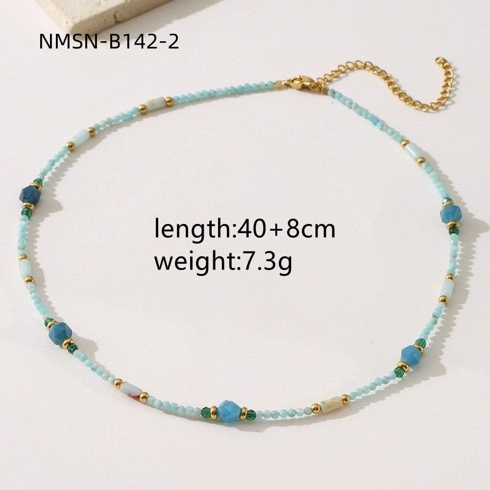Necklace with blue beads and gold accents on a white background