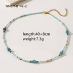 Necklace with blue beads and gold accents on a white background