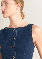 Winged Meadow Co. blue denim sleeveless top with wide neckline and decorative gold-rimmed buttons.