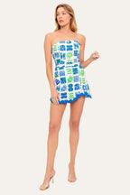 Winged Meadow Co. strapless mini dress with blue and green abstract print, sweetheart neckline, and scalloped trim.
