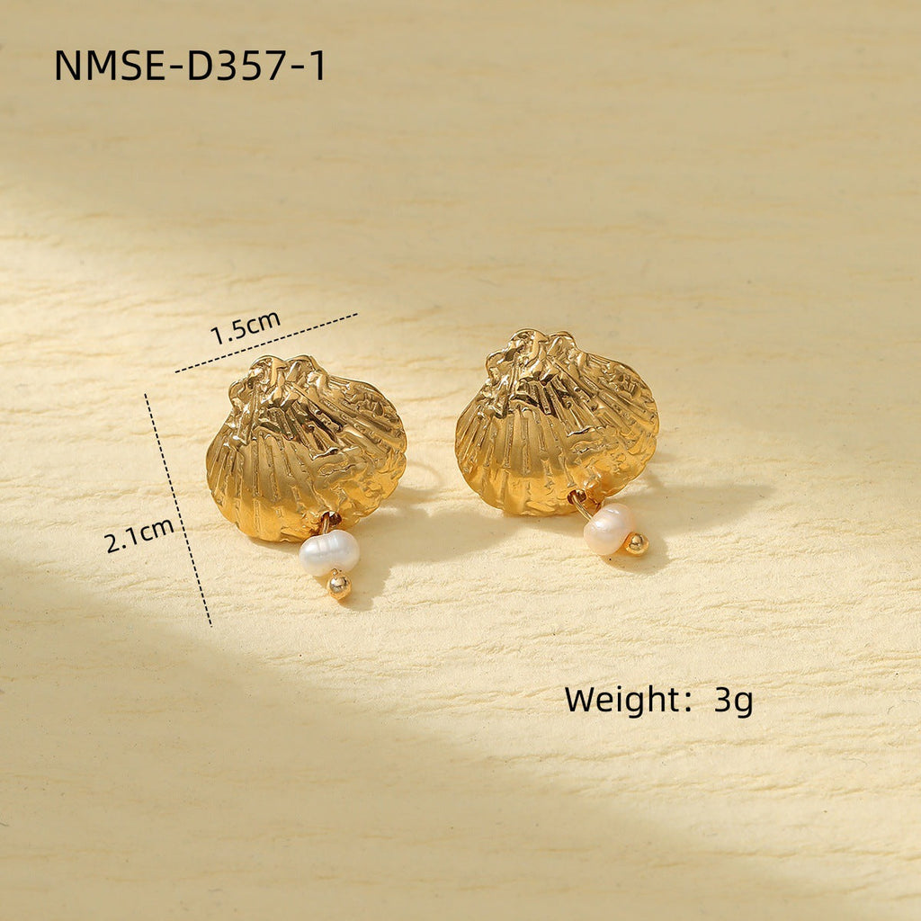 Coastal-inspired shell earrings in gold and silver tones styled flat lay