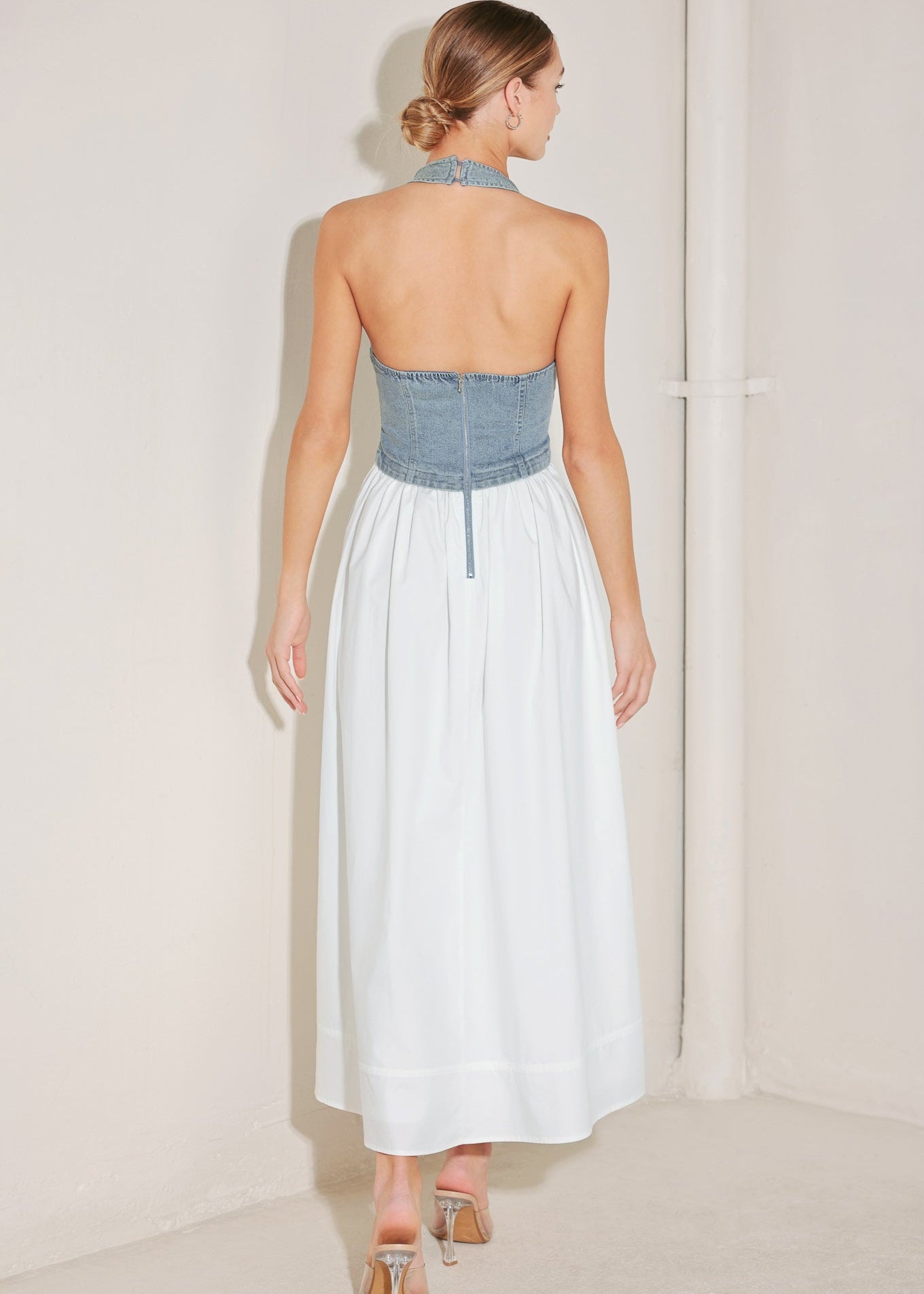 Back view of denim halter midi dress with open back and zipper closure