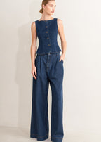 Winged Meadow Co. dark wash denim sleeveless vest top with wide neckline and button front closure.