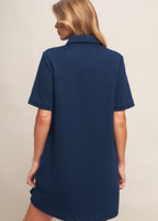 Back view of navy textured knit mini dress with clean minimalist design