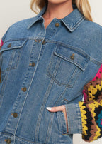Side view of washed denim jacket featuring crochet contrast sleeves
