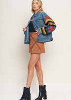 Back view of washed denim jacket with crochet woven sleeve design