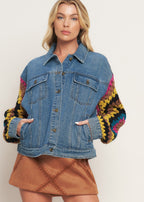 Close up of crochet sleeve detail on washed denim jacket