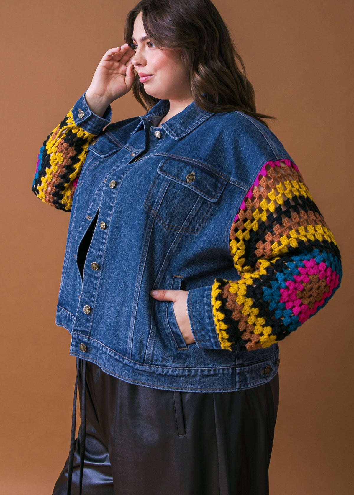 Side view of plus size washed denim jacket with crochet sleeve contrast