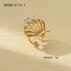 Gold shell-shaped ring with measurements and weight on a wooden surface