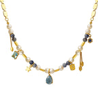 Necklace with pearls, gemstones, and gold accents on a white background