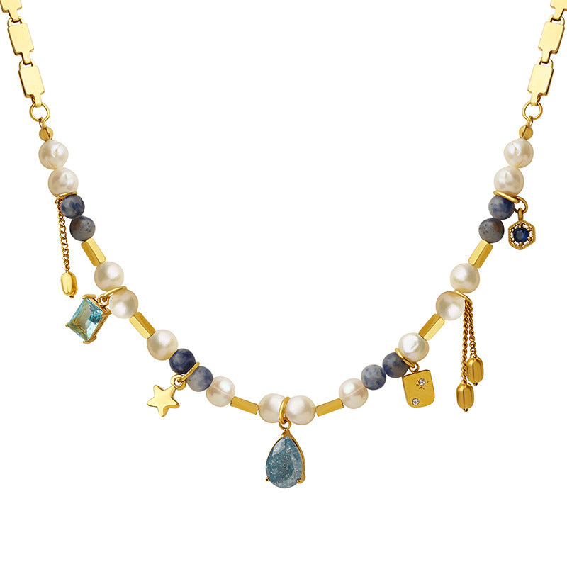 Necklace with pearls, gemstones, and gold accents on a white background
