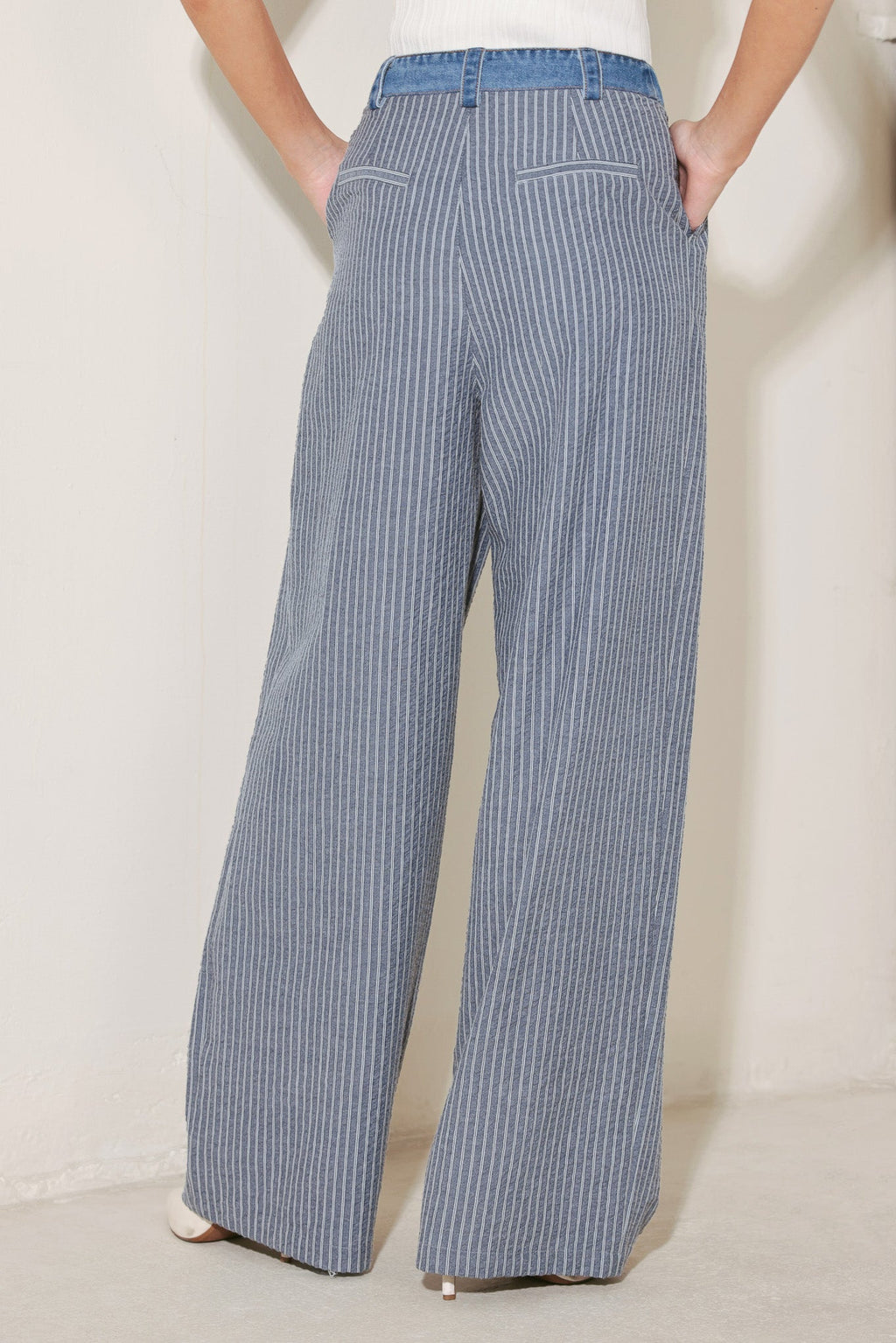 Back view of pinstripe wide leg seersucker pants with tailored fit