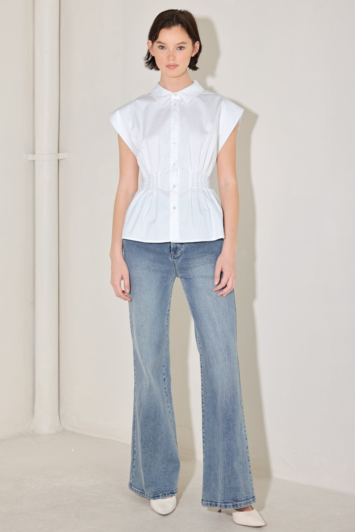 White peplum corset waist blouse styled with light wash denim