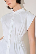 White cotton woven blouse featuring structured corset waist and button front