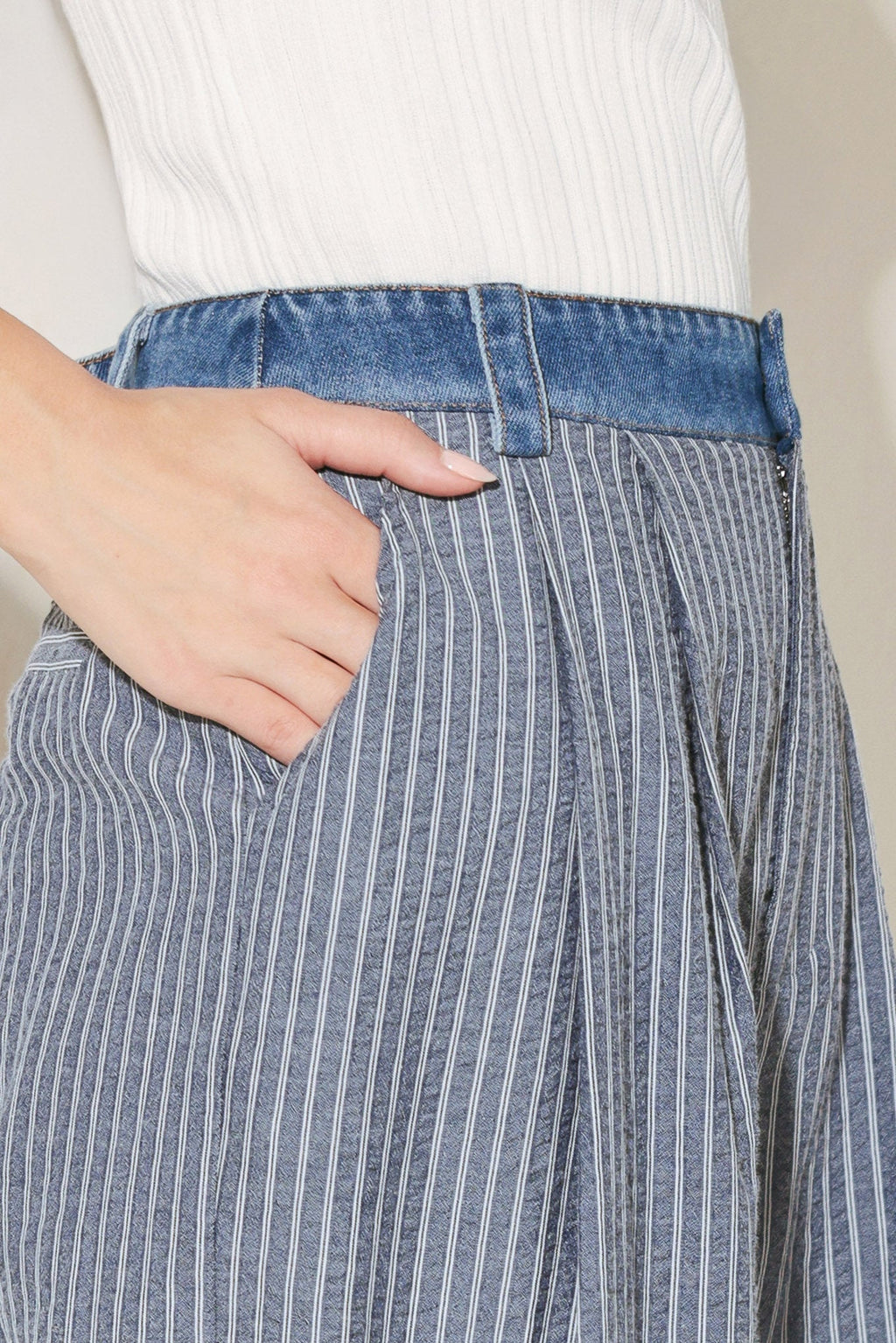 Close up detail of striped seersucker fabric and denim waistband