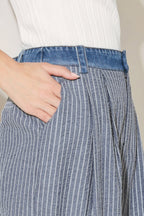Close up detail of striped seersucker fabric and denim waistband