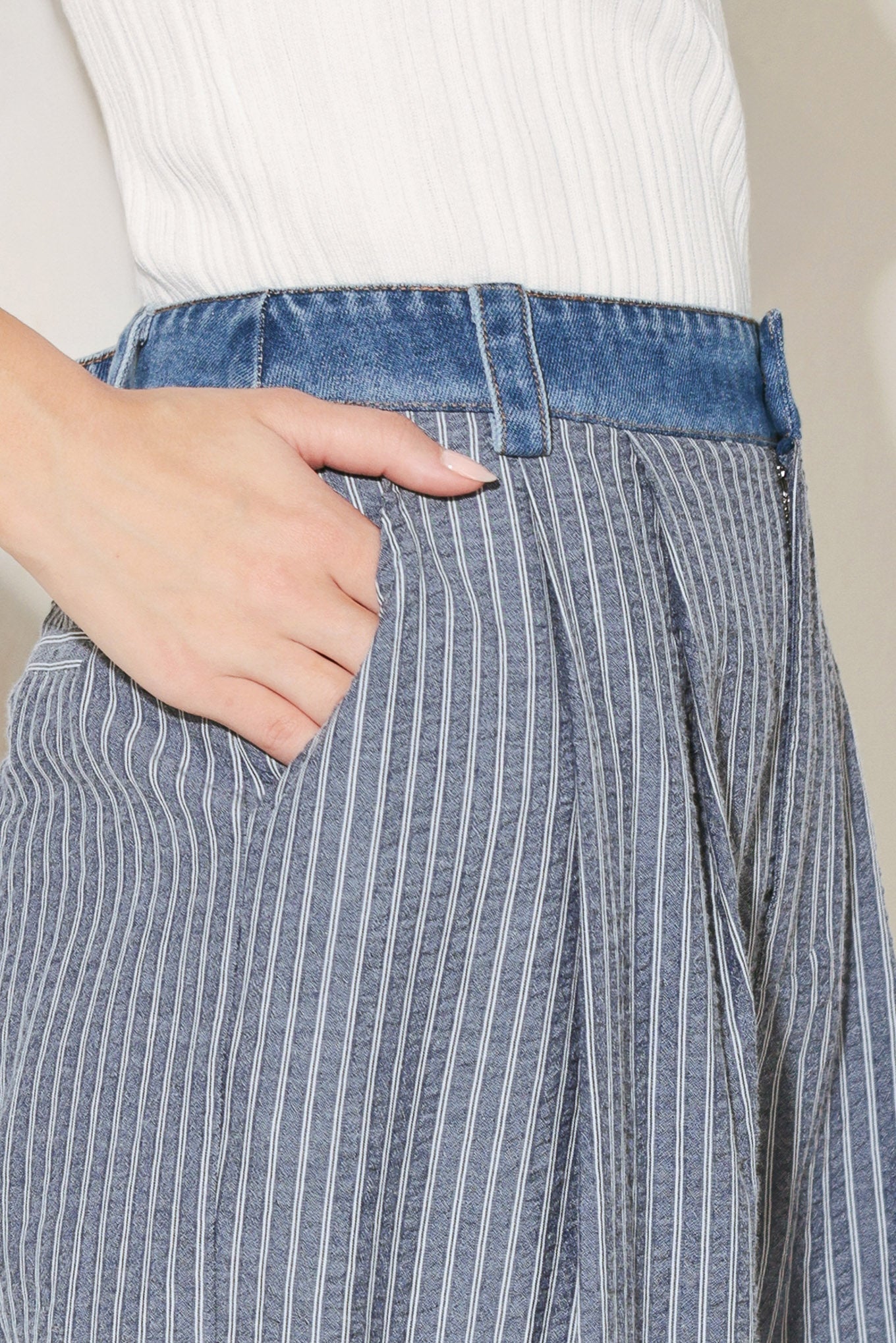 Close up detail of striped seersucker fabric and denim waistband