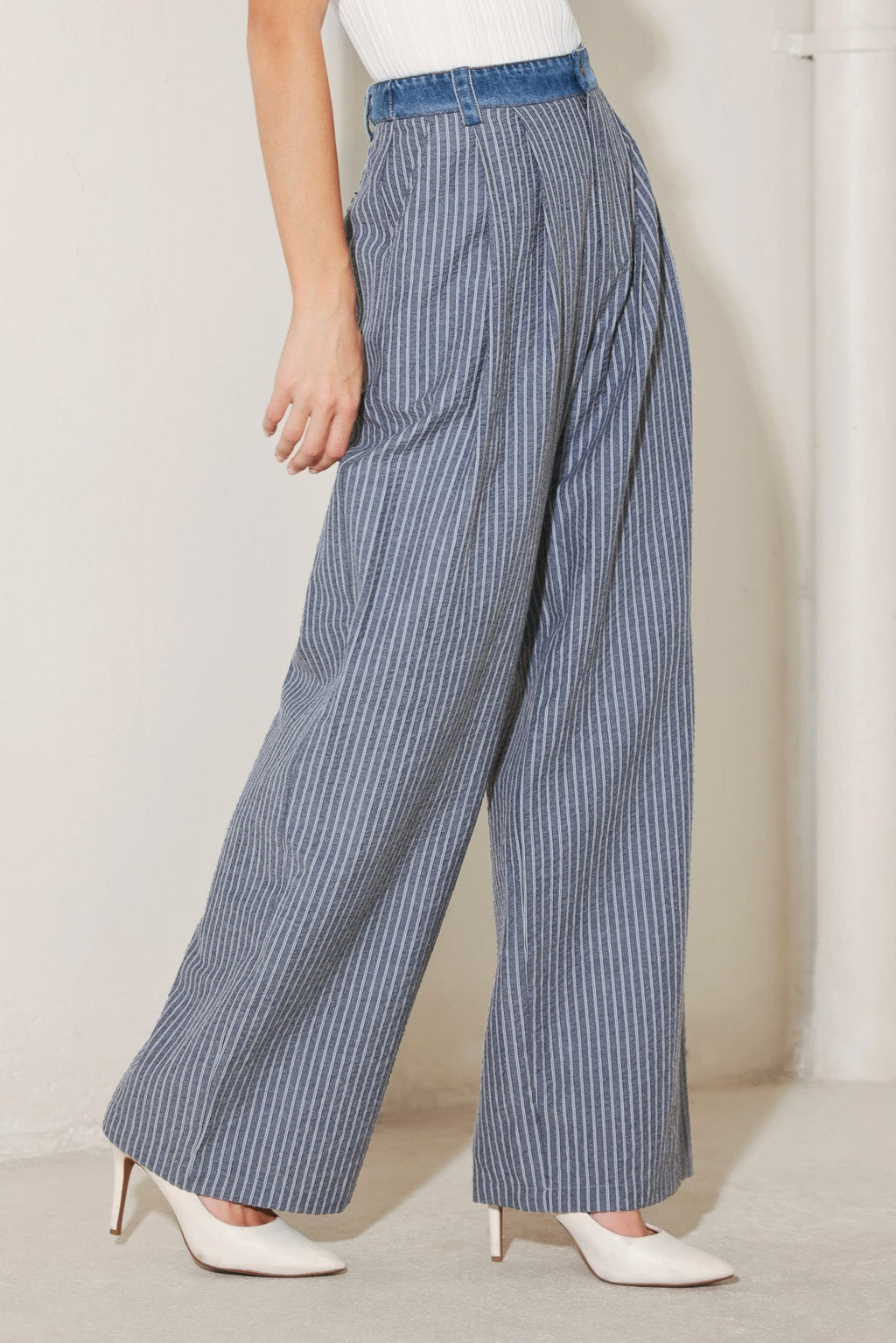 Side view of striped seersucker wide leg trousers with relaxed silhouette