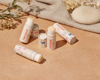 Five lip balm tubes with 'Pure Good' branding on a light green background