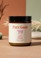 Jar of 'Pure Good' tallow balm on a pink background