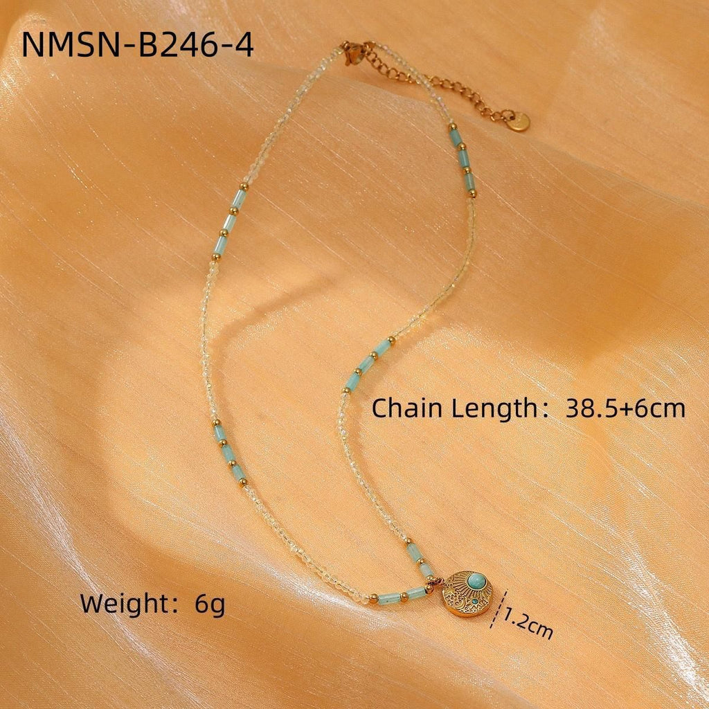 Necklace with turquoise beads and gold accents on a wooden surface, showing chain length and weight.