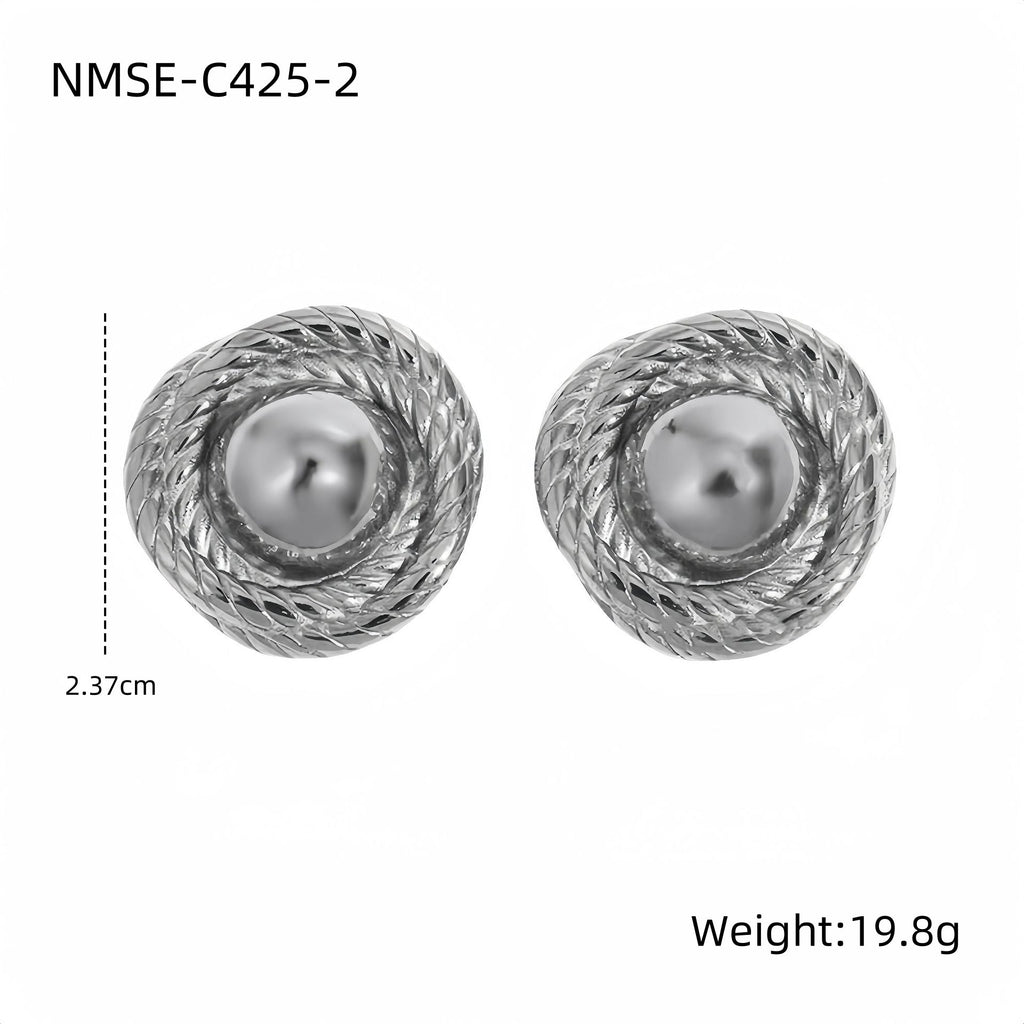 Pair of silver earrings with pearl center on a white background