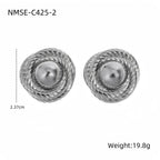 Pair of silver earrings with pearl center on a white background