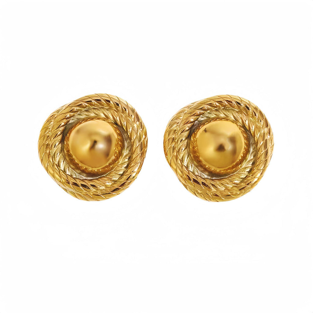 Model wearing spiral gold stud earrings with statement design