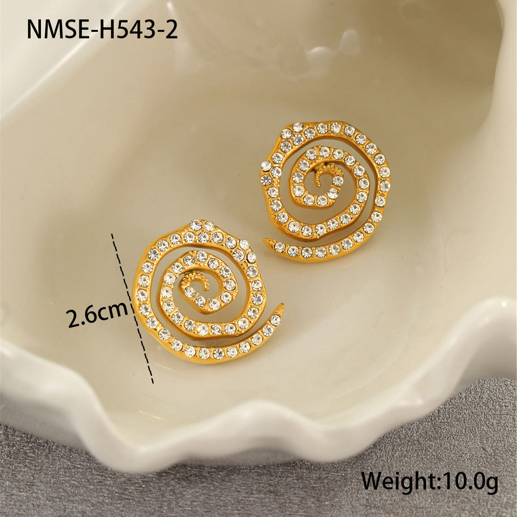 Gold spiral earrings with rhinestones on a shell, showing measurement and weight.