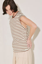 Woman wearing a striped sleeveless top against a plain background