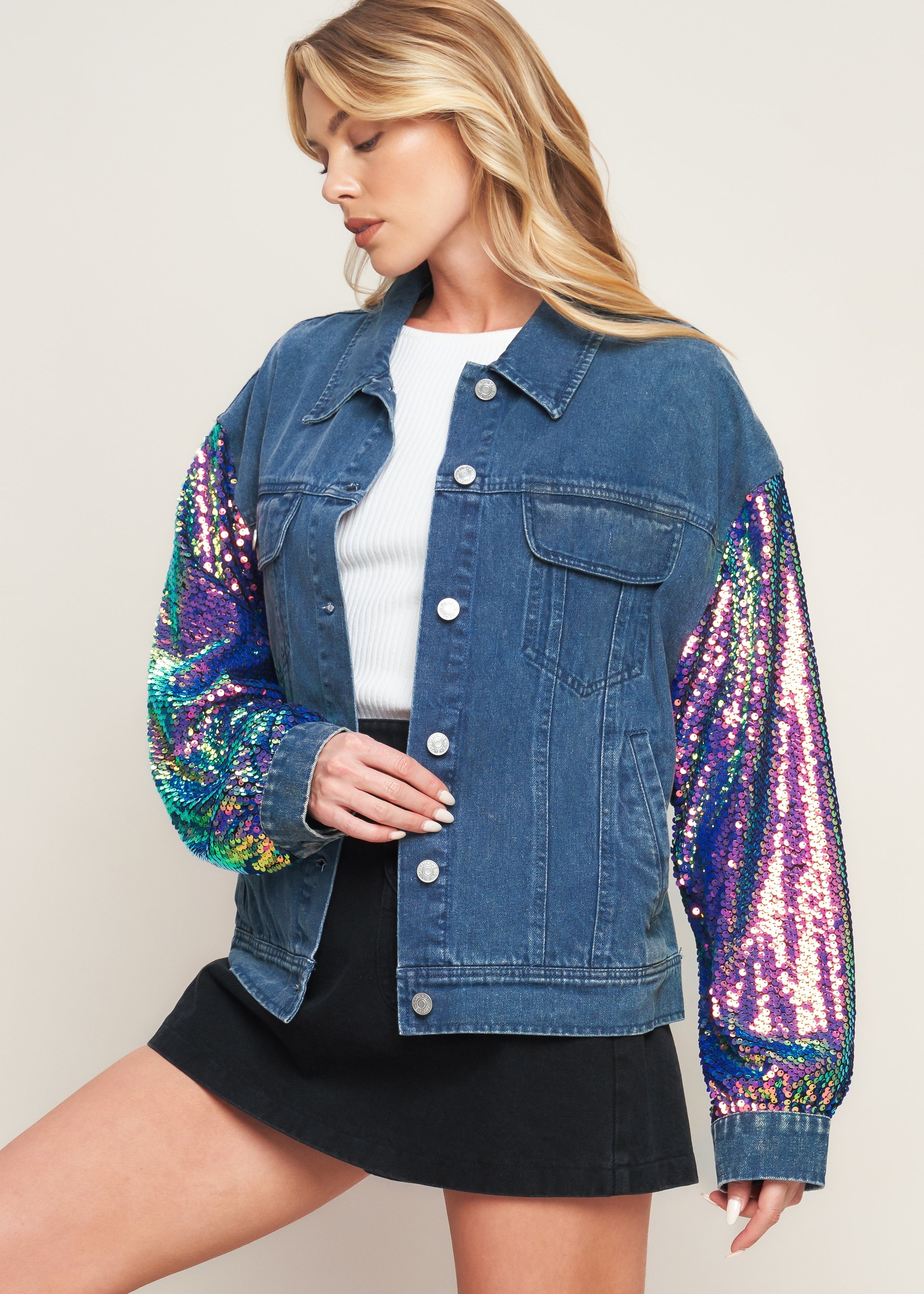 Stylish women’s denim jacket with bold sequin sleeves worn with black skirt modern statement outerwear