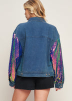 Back view of women’s denim jacket with multicolor sequin sleeve detail and classic washed denim design